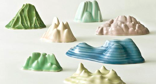 Green, yellow, pink, and blue ceramics of miniature mountains.