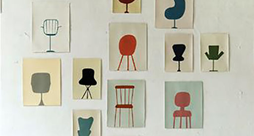 Drawings of chairs on a wall.