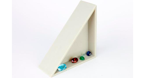 White triangle with blue, red, green and navy gems lined inside it.