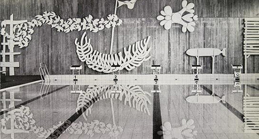 Black and white photo of a pool with white decor on the walls.