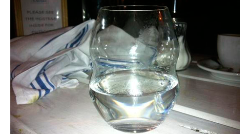 Glass of water with a napkin.