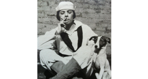 Black and white photo of a woman smoking with a dog.