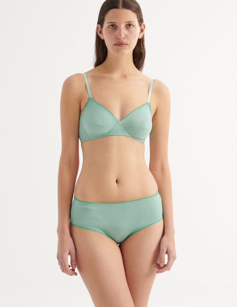 a model in the josephine hipster and antonia bralette in sage green