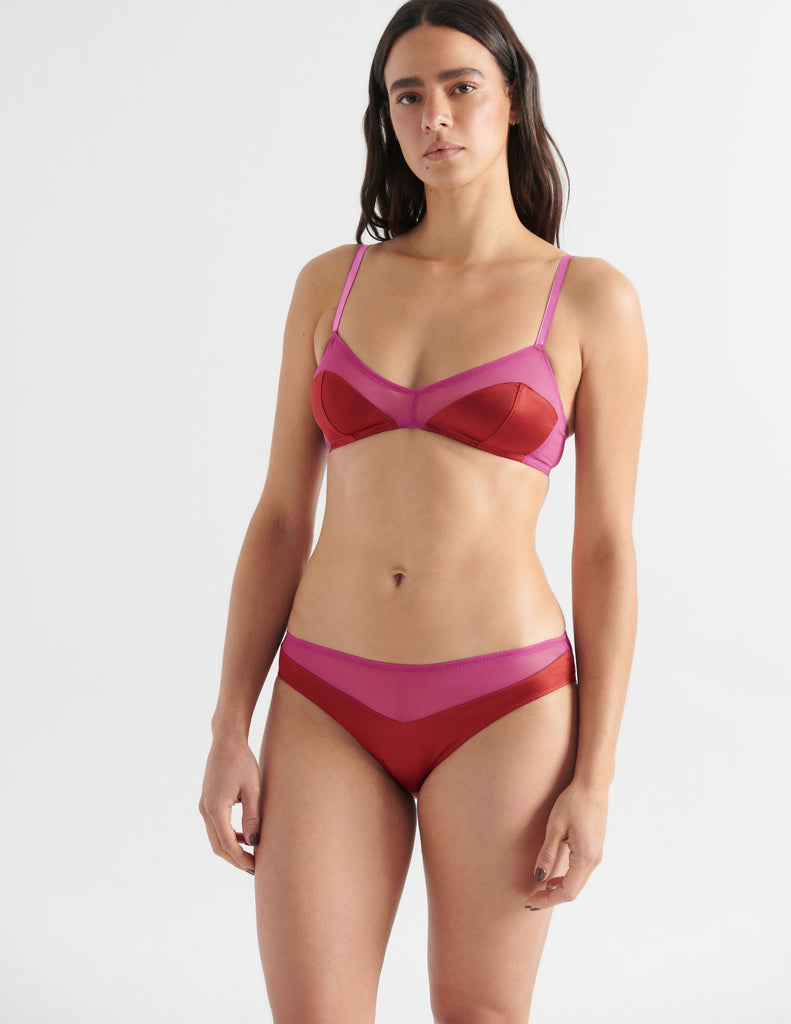 a model in the beatrice bralette and aaron panty in sangria berry red