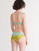 a model from the back in the beatrice bralette and aaron panty in green and blue hummingbird