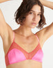 A model wearing the beatrice bralette in pink silk