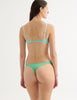 a model from the back in the beatrice bralette and maya thong in sprout green