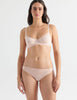 A model wearing the Beau underwire bra in light pink nude cotton