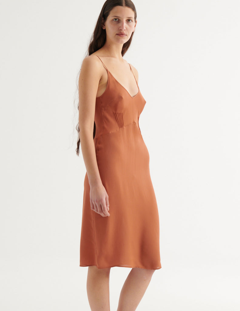 a three-quarters photo of a model in the cadel slip in cocoa brown