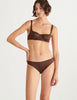 a model in the gita underwire bra and gwyneth panty in carob brown