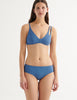 a model in elias bikini top and ezra bikini bottom in fog blue