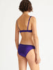 a model in the gita underwire bra and gwyneth panty in aster purple