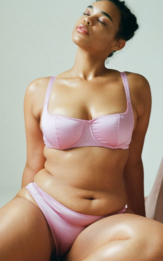 A model wearing the Gita Bra and Gwyneth Panty in pink silk.