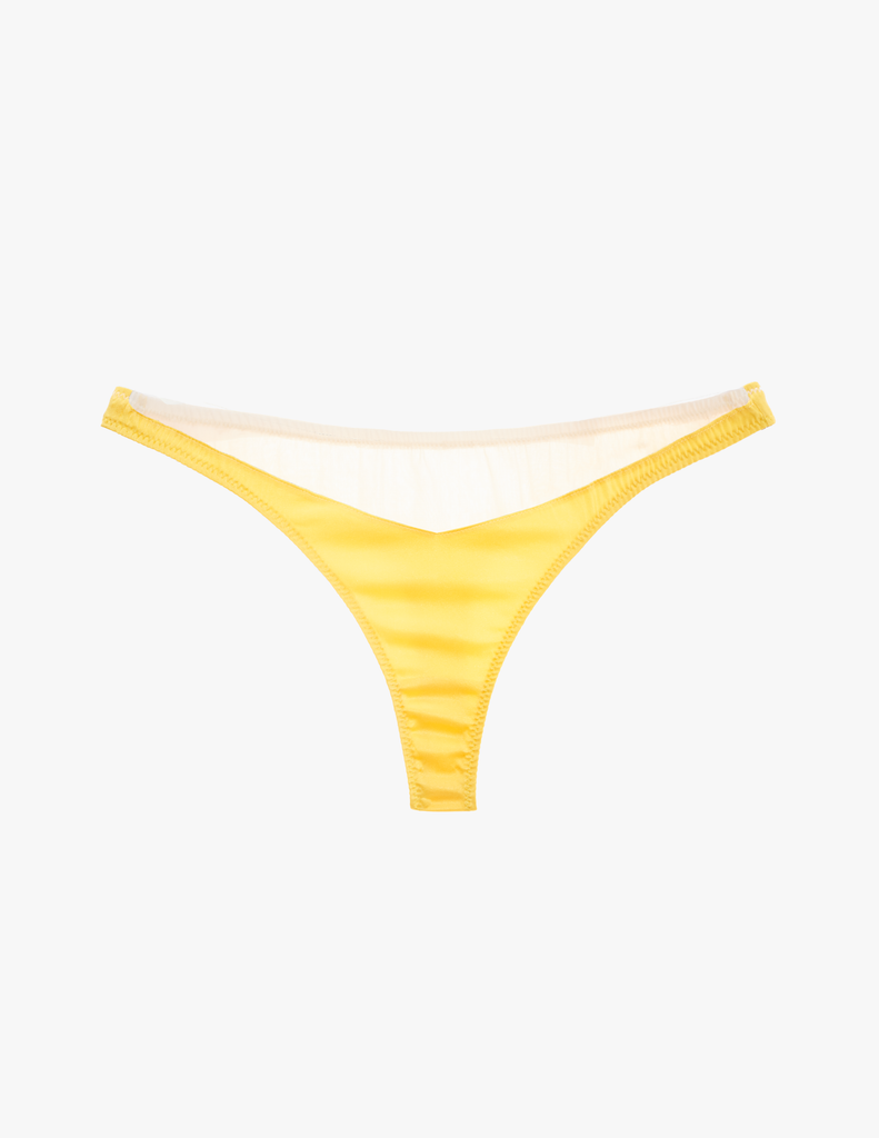 a flat lay image of the maya thong in yellow sun