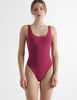 a model in the red brown luna one piece swimsuit