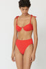 a model in the myriam underwire bikini top in poppy red and mallory poppy red hipster