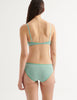 a model from the back in the sofia underwire bra in sage and the isabella panty in sage green