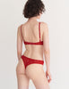 a model in the tamara bralette and tine thong in cardinal red