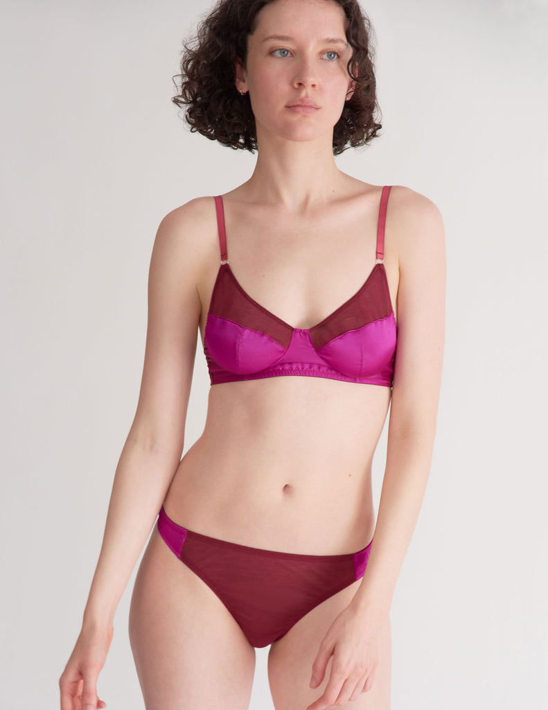 a model in the maude thong and willow bralette in amaranth magenta