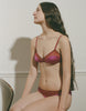 a model wearing the beatrice bralette and aaron panty in purple silk