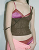 a model wearing the beatrice bralette and georgia cami in pink silk and brown lace