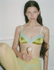 a model holding an ice cream cone wearing the beatrice bralette in green silk hummingbird colorway