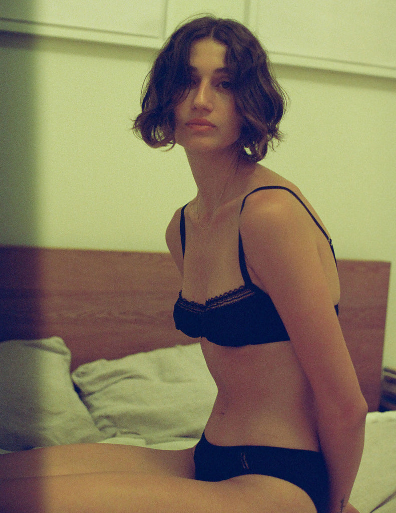 A model wearing the chloe bra and sonja panty in black cotton