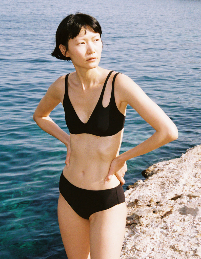 a model wearing the elias swim suit in black