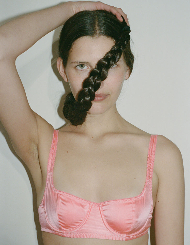 a model wearing the gita bra in pink silk