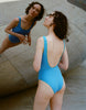 a model wearing the luna one piece in iris blue