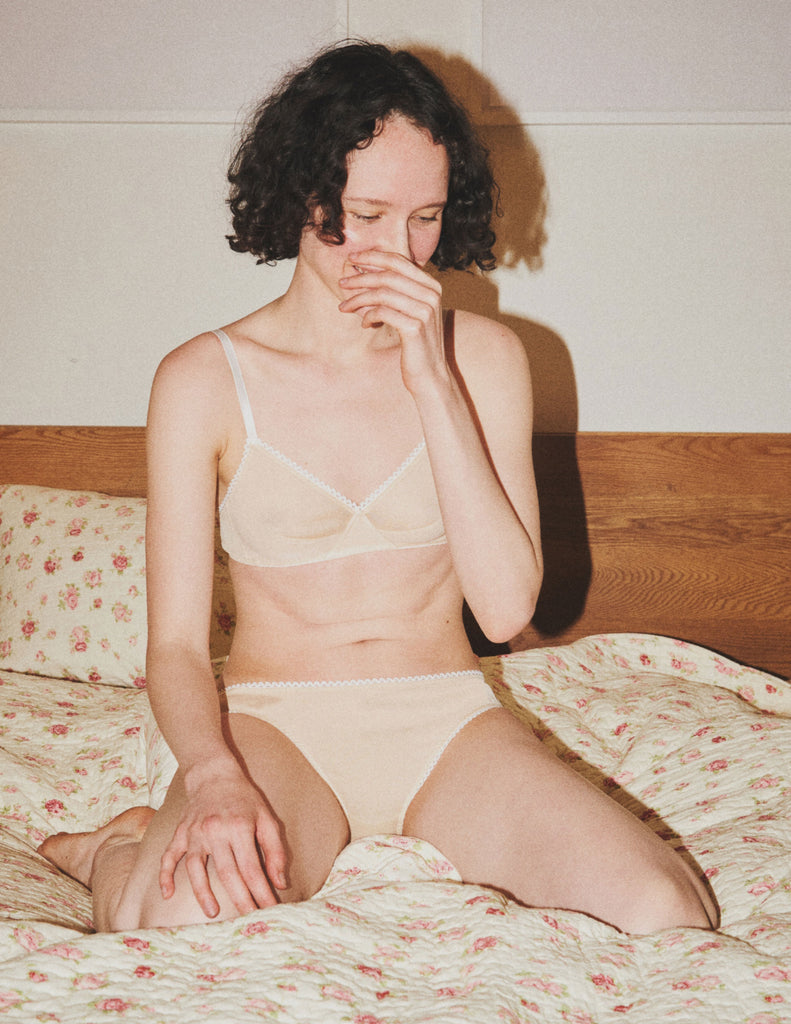 model wearing undyed cotton bra with matching panties