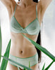 a model wearing the sofia underwire bra in light green cotton