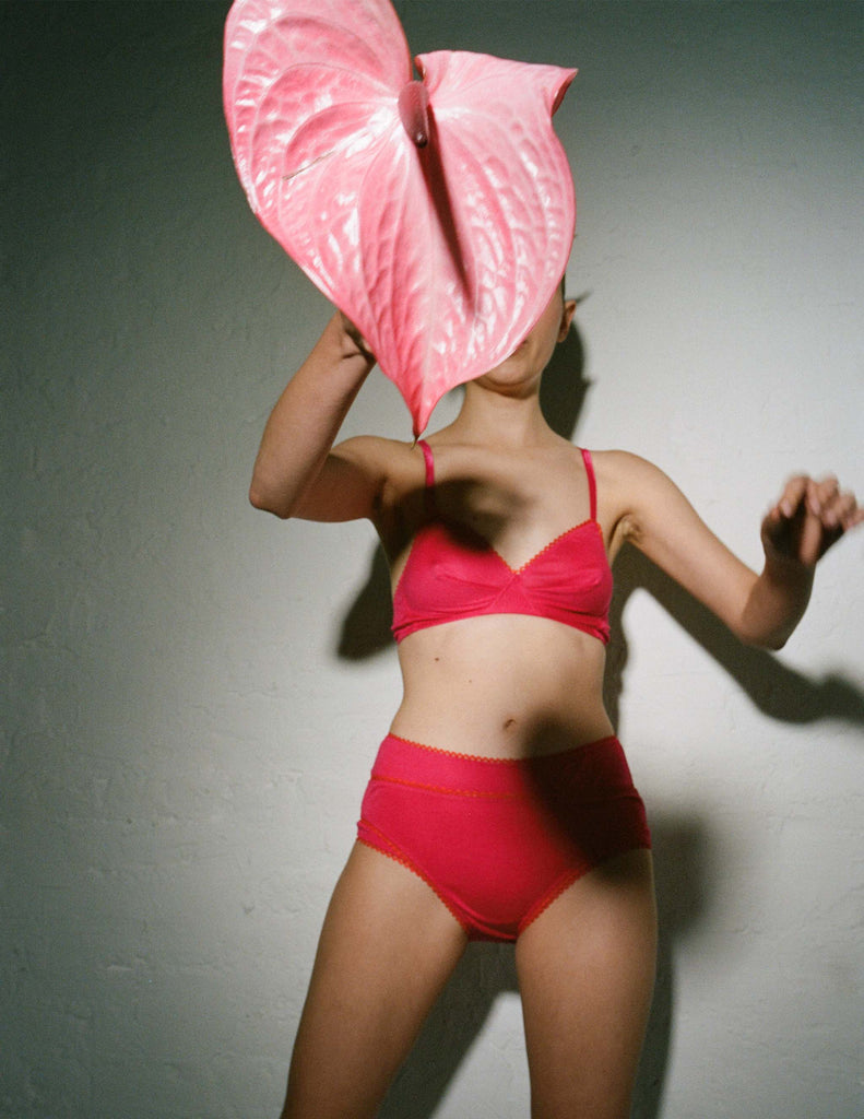 woman wearing pink cotton bralette and layered panties by Araks